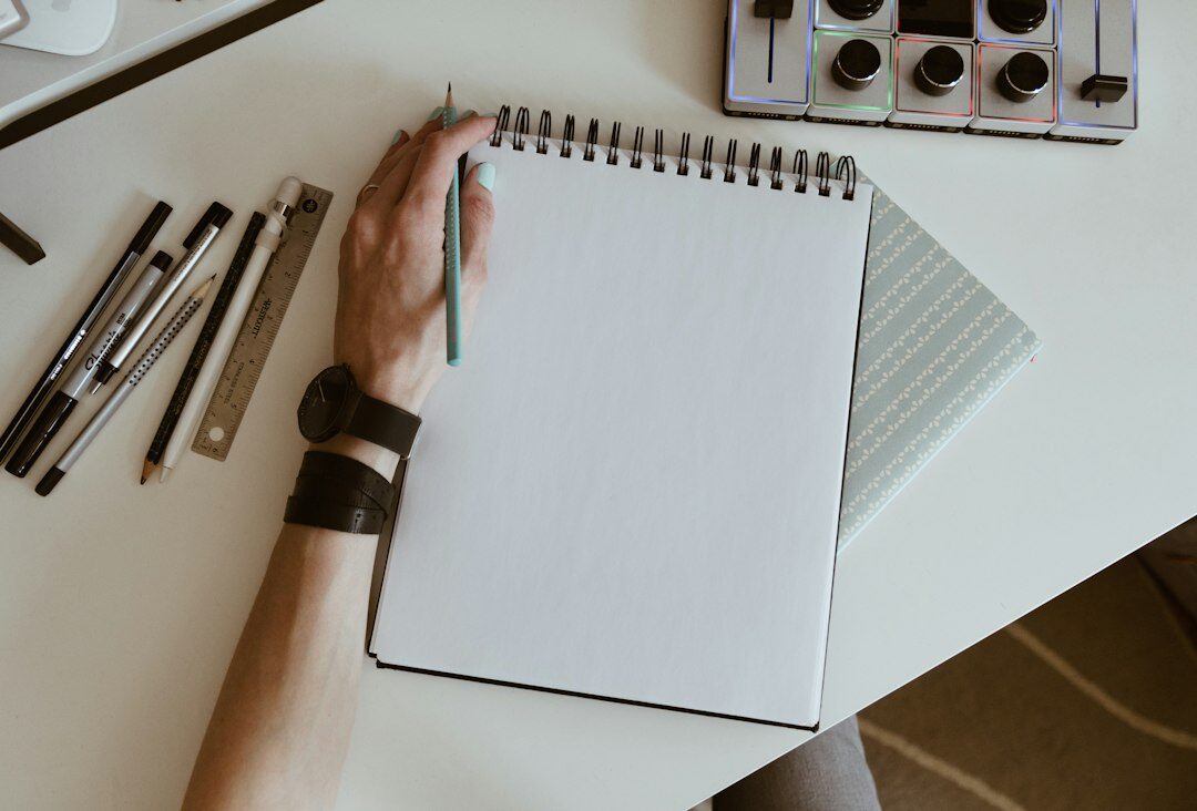 person writing goals in notebook