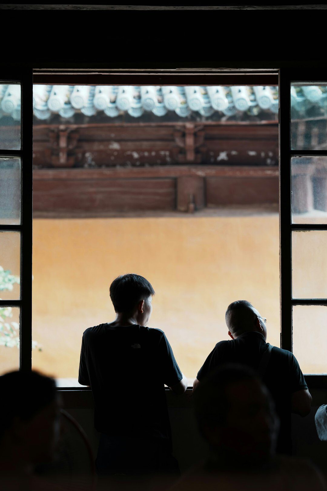 Person meditating peacefully by a window