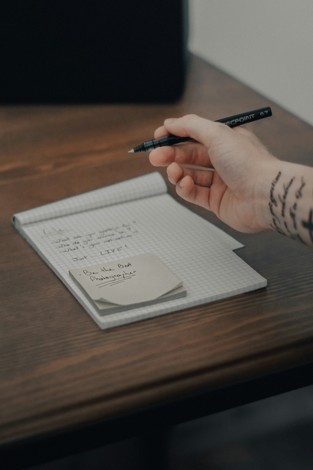 person writing goals in notebook