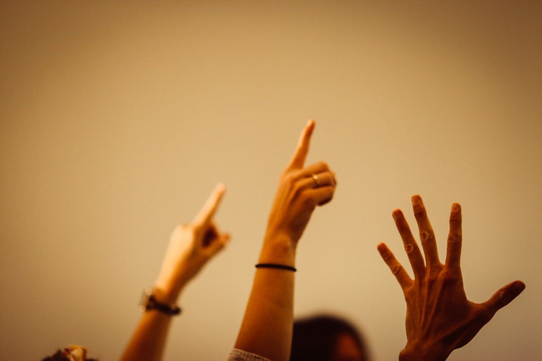 People raising hands during a group workshop